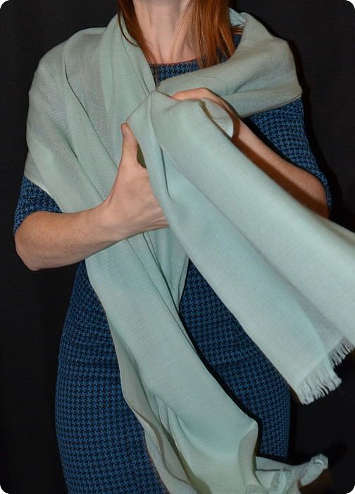 Empar is wearing a seafoam blue ultra-light diamond weave Pumori shawl, 100% pashmina