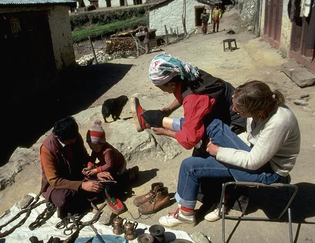 Above and below: Tourist in Namche Bazar, struggling to find Tibetan boots large enough for her Western feet