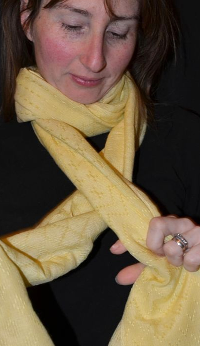 Empar is wearing a fine yellow shawl with fancy weave and beading